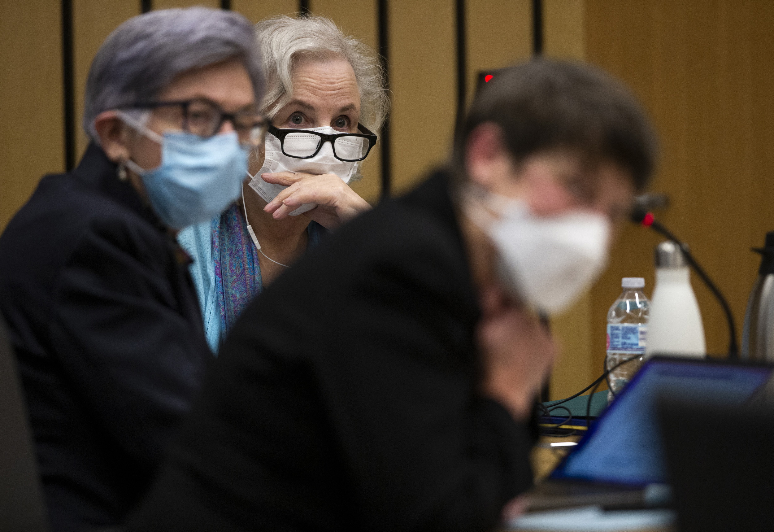 Romance writer Nancy Crampton Brophy, background, accused of killing her husband, Dan Brophy, in June 2018, is surrounded by her defense attorneys in court in Portland.