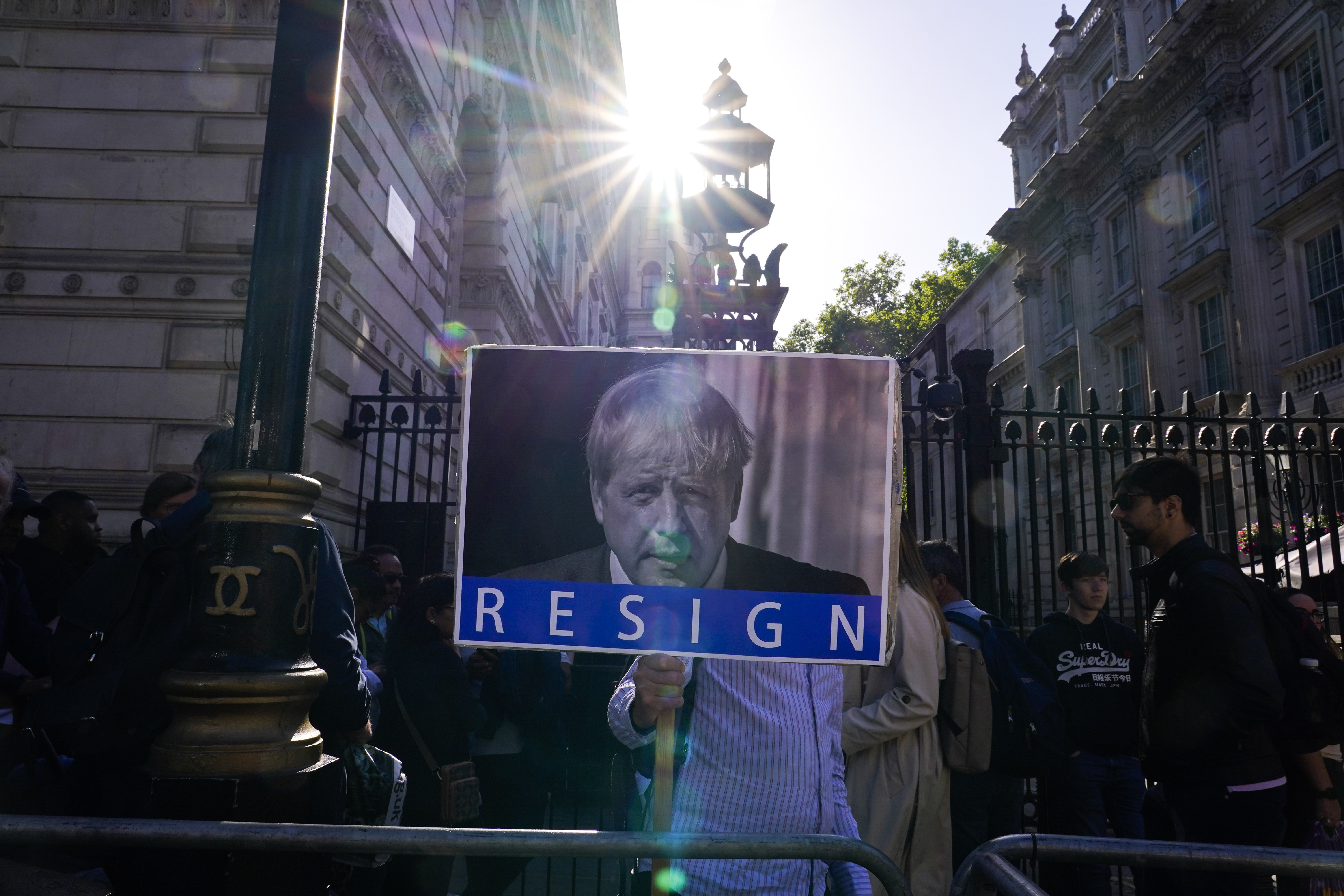 A demonstrator holds a placard depicting Britain's Prime Minister Boris Johnson after an investigative report blamed Johnson and other senior leaders for allowing government parties that broke the UK's COVID-19 lockdown rules. 