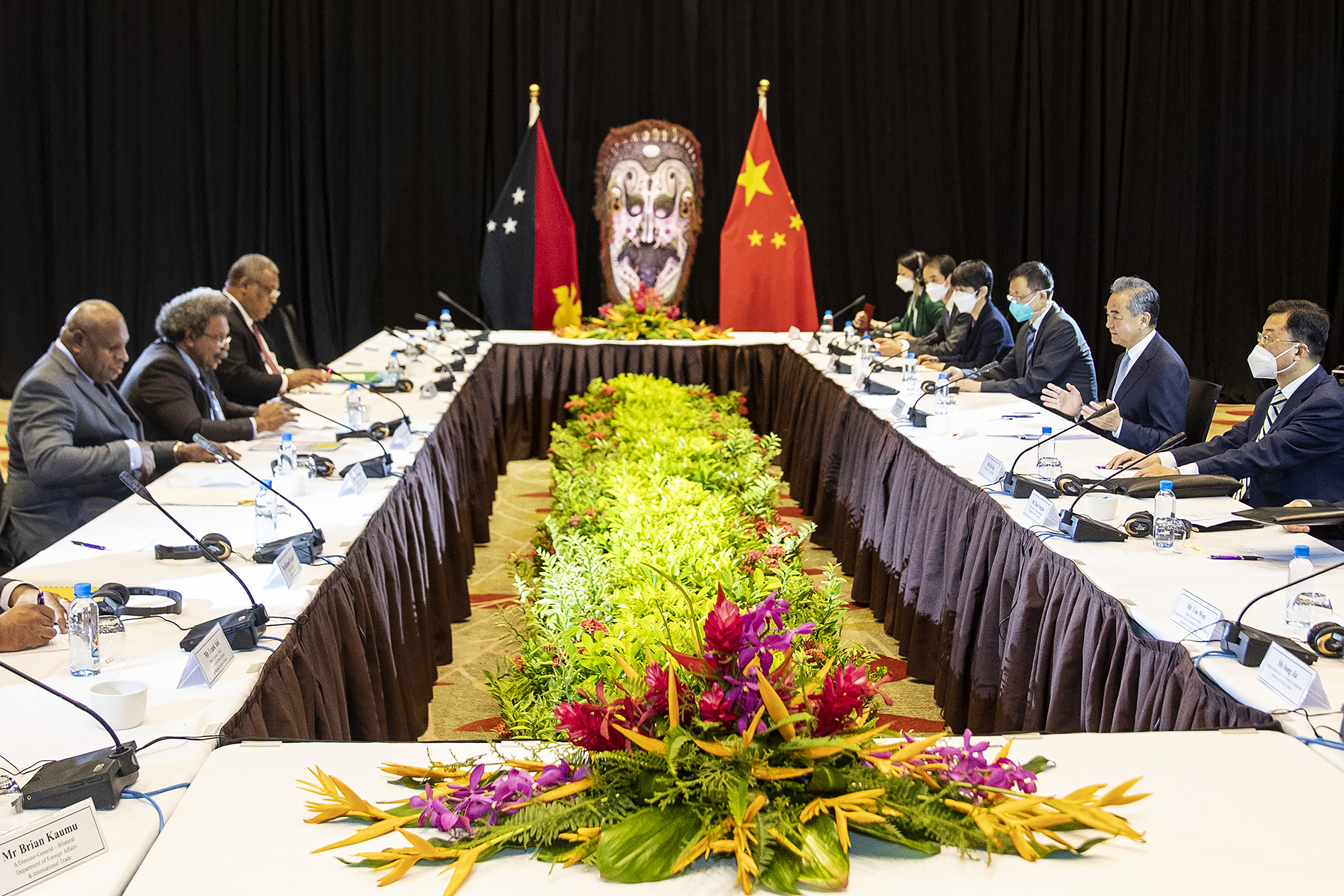 In this photo released by Xinhua News Agency, visiting Chinese Foreign Minister Wang Yi, second from right, holds talks with Minister for Foreign Affairs and International Trade of Papua New Guinea Soroi Eoe, second from left, in Port Moresby, Papua New Guinea, on Friday June 3, 2022. The foreign ministers of Australia and China were both making their final stops Friday, June 3, 2022 on what has become an island-hopping diplomatic duel in the South Pacific. (Bai Xuefei/Xinhua via AP)