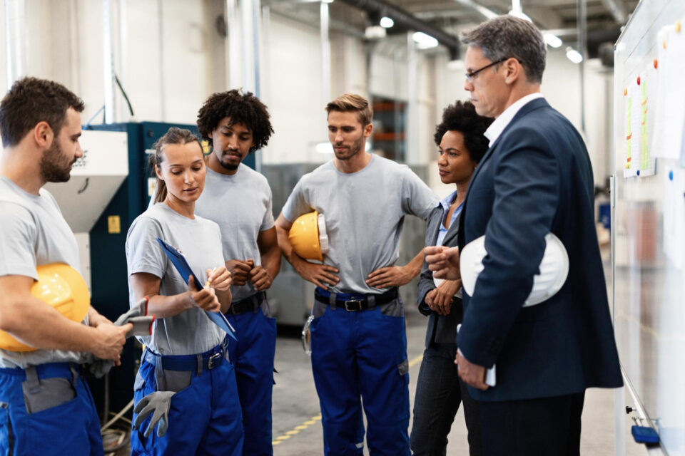 group-workers-having-meeting-with-company-managers-factory-focus-is-female-worker-is-presenting-development-reports