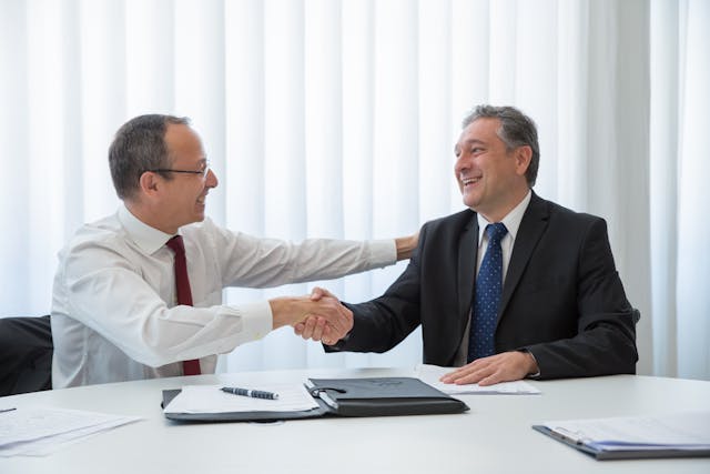 Photo by Kampus Production: https://www.pexels.com/photo/men-looking-at-each-other-while-doing-hand-shake-8428080/